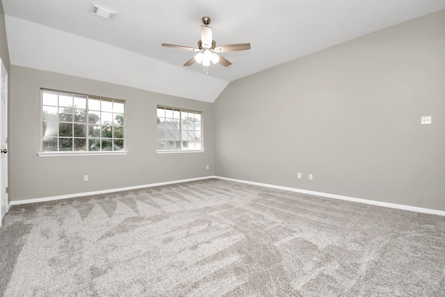 unfurnished room featuring carpet floors, lofted ceiling, and ceiling fan