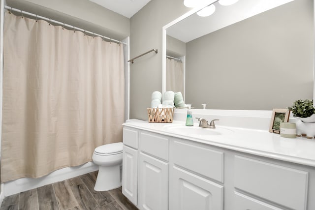 full bathroom featuring toilet, vanity, wood-type flooring, and shower / bath combo with shower curtain