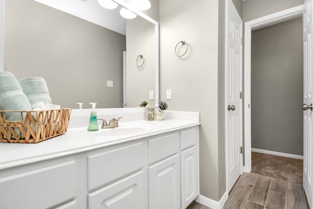 bathroom featuring hardwood / wood-style flooring and vanity