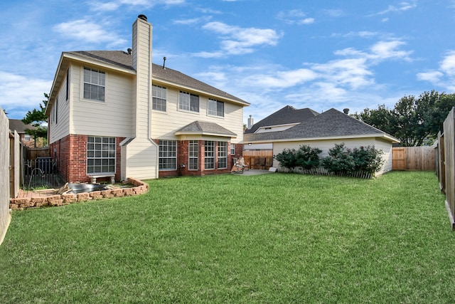 rear view of property featuring a yard