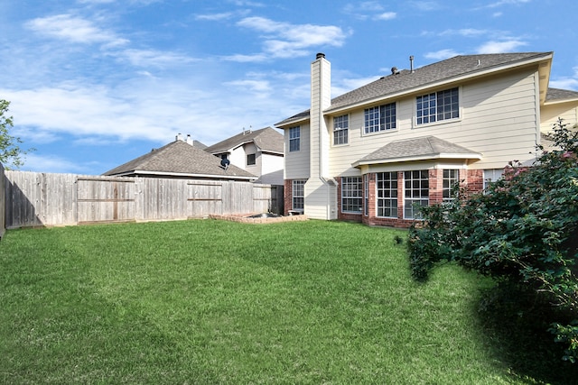 rear view of house with a yard