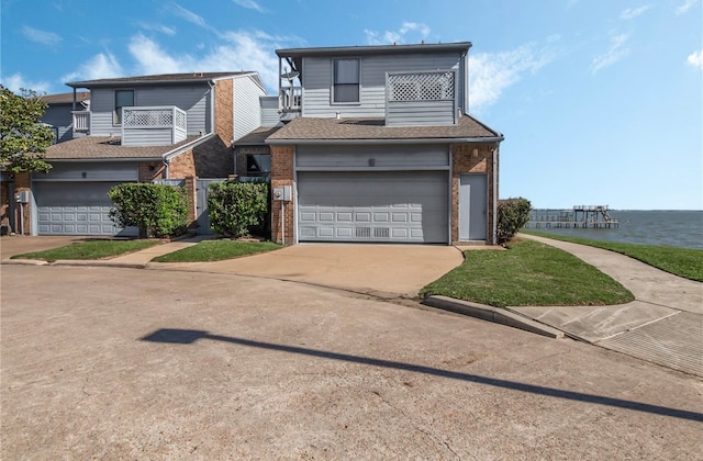 view of front facade with a garage and a water view