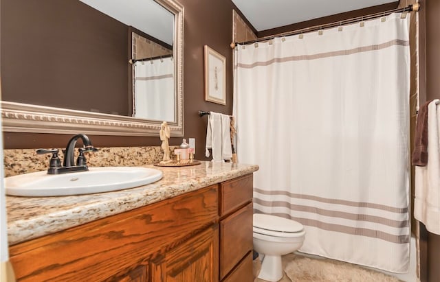 bathroom with toilet, curtained shower, and vanity