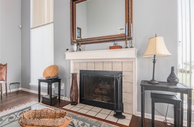 sitting room with light hardwood / wood-style flooring and a tile fireplace