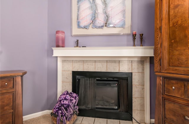 room details featuring a tile fireplace and tile patterned flooring