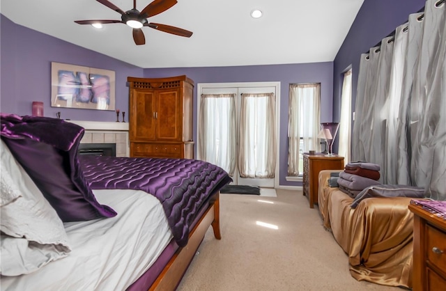 carpeted bedroom featuring vaulted ceiling and ceiling fan