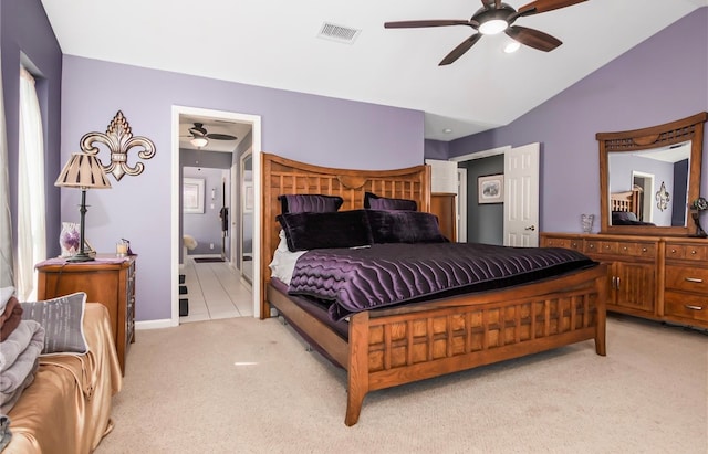 bedroom featuring light colored carpet, vaulted ceiling, and ceiling fan