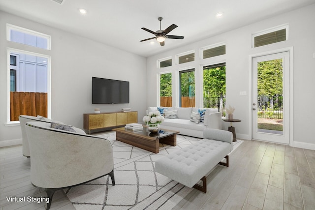 living room featuring ceiling fan and light wood-type flooring