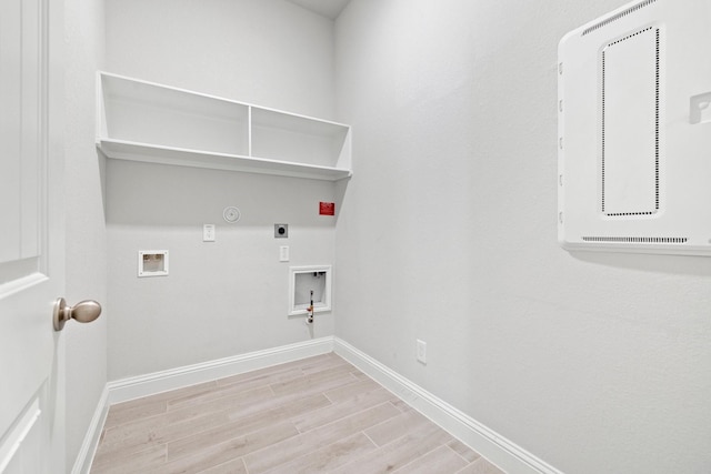 clothes washing area featuring hookup for an electric dryer, hookup for a gas dryer, washer hookup, and light hardwood / wood-style flooring