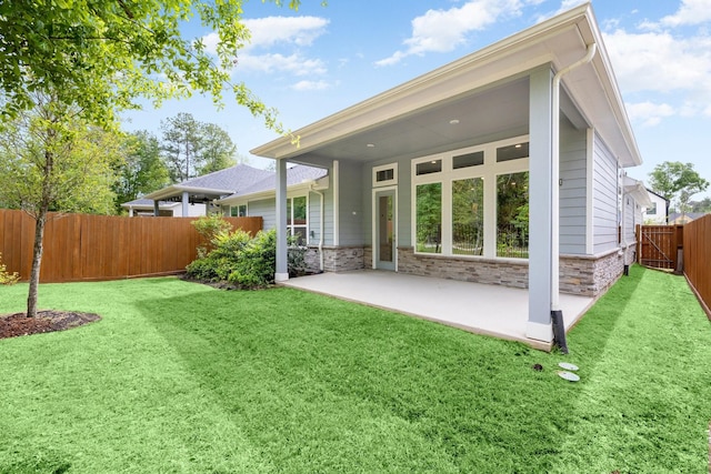 back of property featuring a yard and a patio