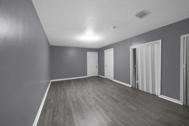 unfurnished bedroom with dark hardwood / wood-style floors