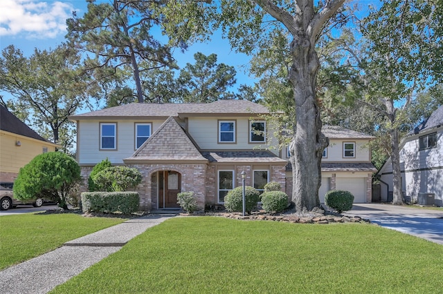 view of front of home with a front lawn, central AC unit, and a garage