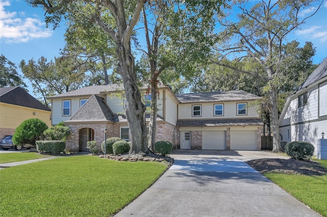 view of front of house with a front yard and a garage