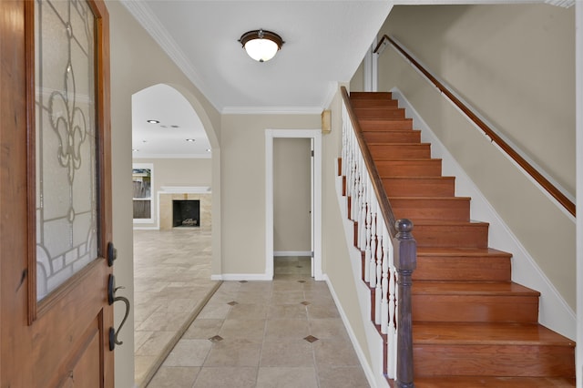 entrance foyer with ornamental molding and light tile patterned floors