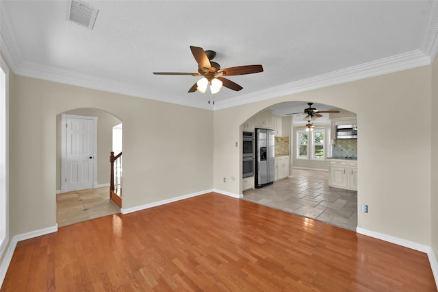 unfurnished living room featuring crown molding, light hardwood / wood-style flooring, and ceiling fan