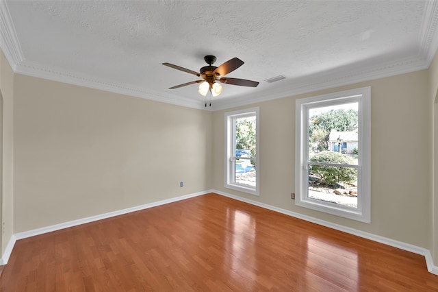 unfurnished room featuring crown molding, hardwood / wood-style floors, and a textured ceiling