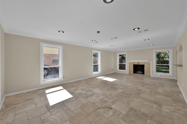 unfurnished living room with crown molding, a wealth of natural light, and a fireplace