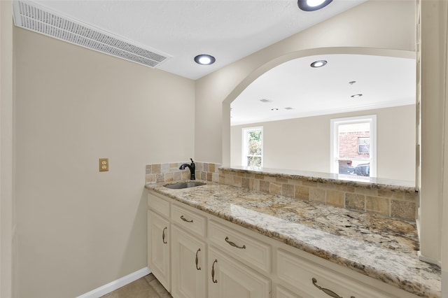 bathroom with vanity and backsplash