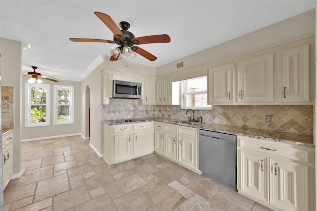 kitchen with stainless steel appliances, tasteful backsplash, sink, and plenty of natural light