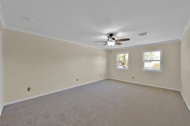 carpeted empty room featuring ornamental molding and ceiling fan