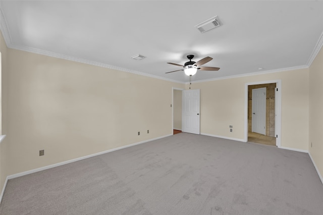 spare room featuring ornamental molding, light colored carpet, and ceiling fan