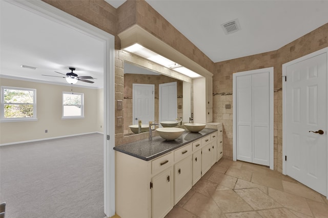 bathroom featuring tile walls, vanity, and ceiling fan