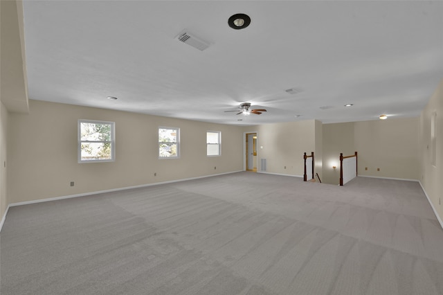 carpeted empty room featuring ceiling fan