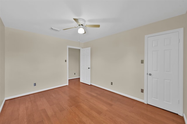 empty room with light hardwood / wood-style floors and ceiling fan