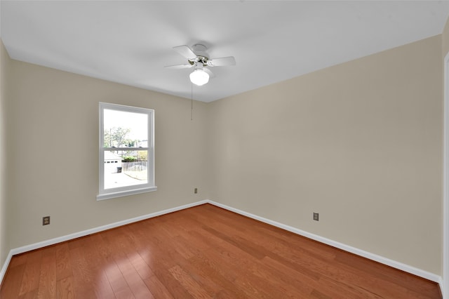 spare room featuring wood-type flooring and ceiling fan