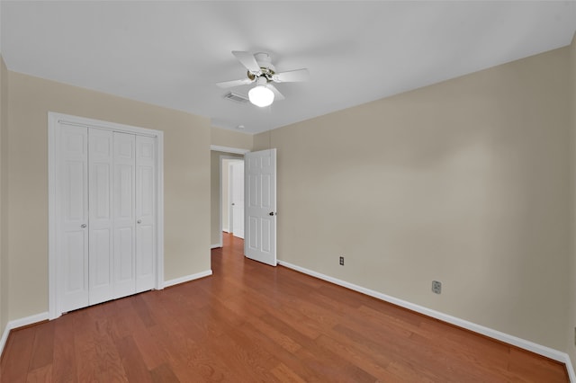 unfurnished bedroom with a closet, ceiling fan, and hardwood / wood-style flooring