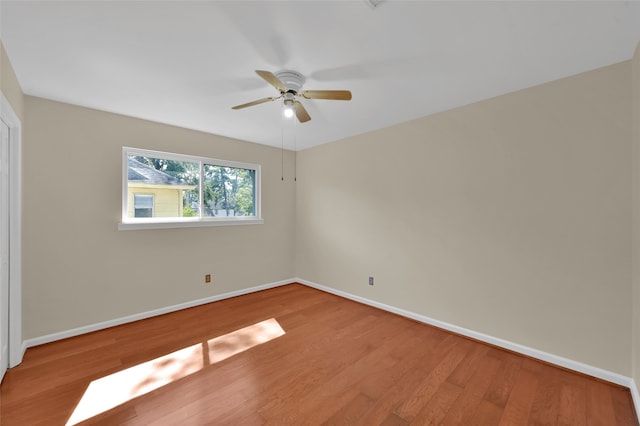 empty room featuring light wood-type flooring and ceiling fan