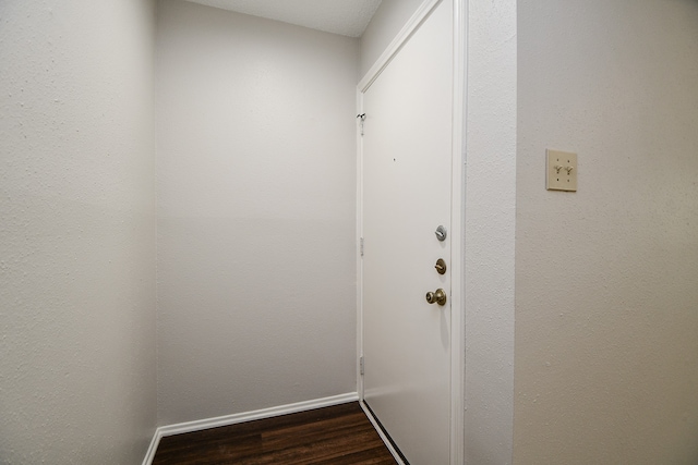 doorway featuring dark wood-type flooring