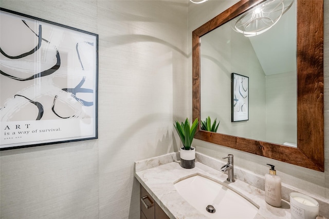 bathroom with vanity and vaulted ceiling