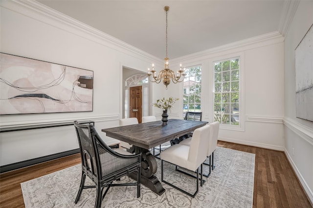 dining room featuring an inviting chandelier, ornamental molding, and hardwood / wood-style floors