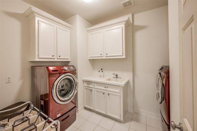 washroom featuring sink, cabinets, washer and clothes dryer, and light tile patterned flooring