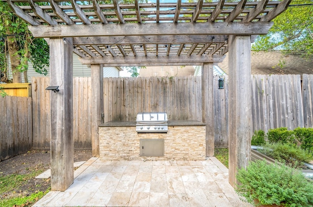 view of patio with an outdoor kitchen, a grill, and a pergola