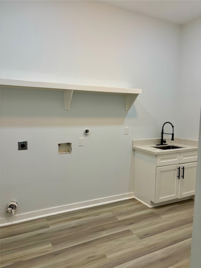 laundry area featuring hookup for a gas dryer, electric dryer hookup, washer hookup, sink, and light wood-type flooring