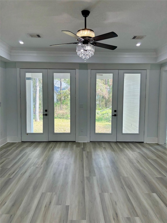 entryway featuring ornamental molding, french doors, light hardwood / wood-style floors, and ceiling fan