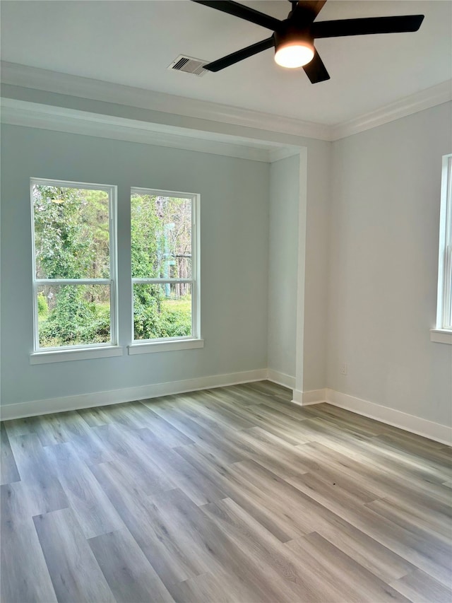 empty room featuring crown molding, light hardwood / wood-style flooring, and ceiling fan