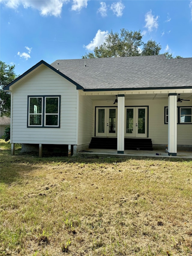 back of house with a yard and french doors