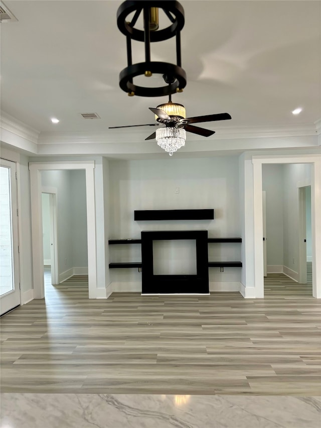 unfurnished living room featuring ornamental molding, light wood-type flooring, and ceiling fan