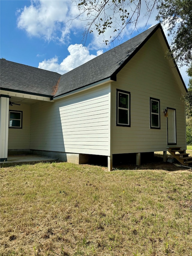 view of side of property featuring a yard