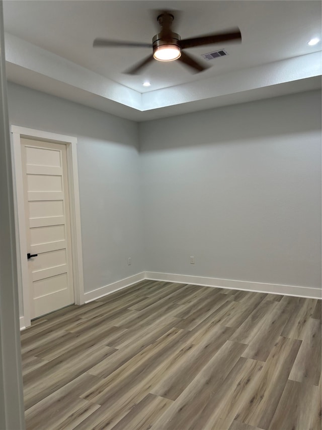 spare room featuring hardwood / wood-style floors and ceiling fan