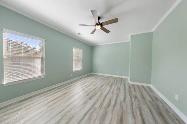 unfurnished room with ceiling fan, light wood-type flooring, and ornamental molding