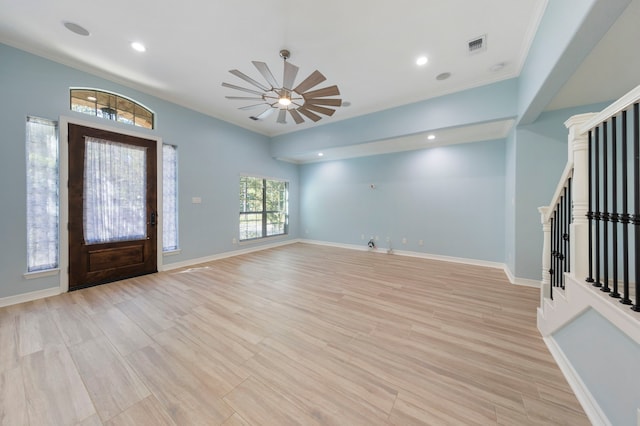 foyer with ceiling fan, light hardwood / wood-style flooring, and ornamental molding