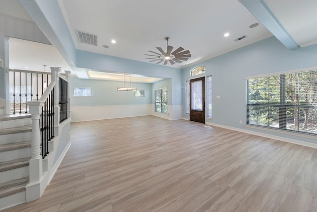 unfurnished living room with light hardwood / wood-style flooring and ceiling fan