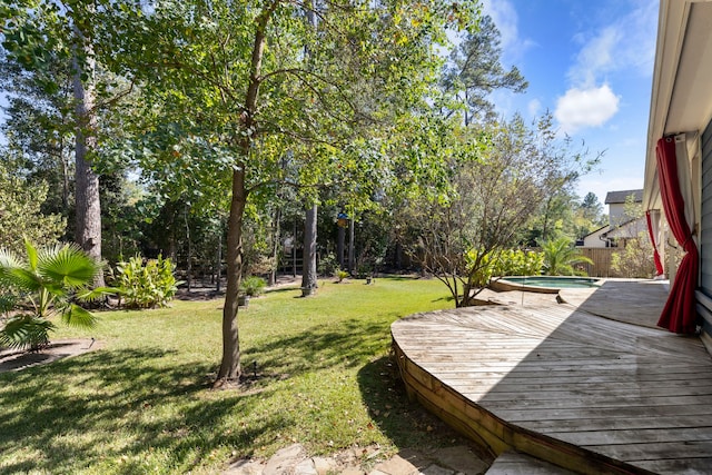 view of yard with a swimming pool side deck