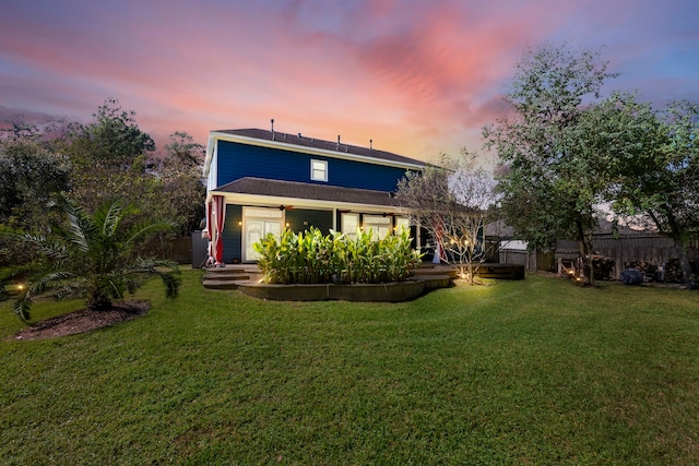 back house at dusk with a yard