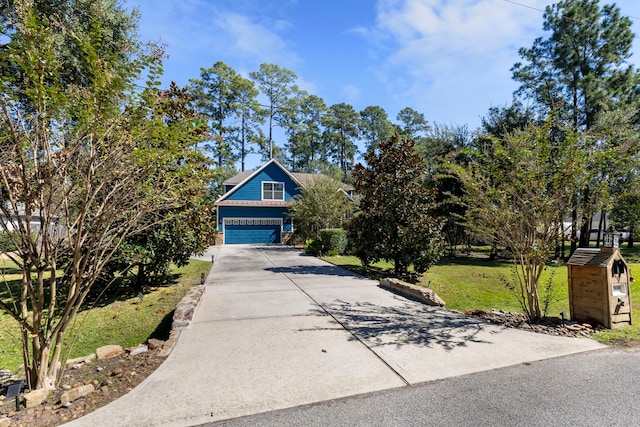 view of front of house featuring a garage and a front lawn