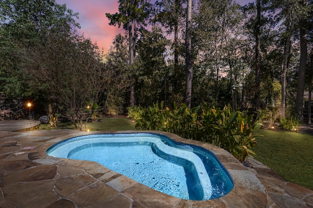 pool at dusk with a lawn